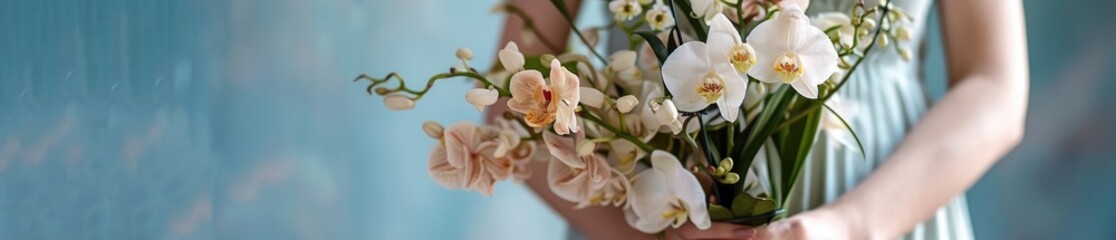 Obraz premium A woman poised hands present a stunning bouquet of orchids