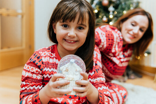 Family joy with Christmas snow globe