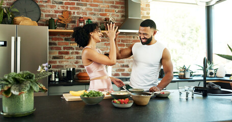 Happy, couple and cooking in kitchen with high five for breakfast, nutrition and success in healthy...