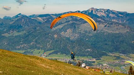 Alpine summer view with a paraglider taking off at Koessen, Kitzbuehel, Tyrol, Austria