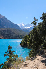 Blue Water Phoskundo Lake in the foreground, and Mountains in the background.