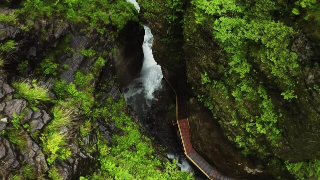 Beautiful canyon with cascading waterfalls and rich green vegetation, offering a perfect backdrop for adventure, nature, travel, hiking, and holiday-themed projects