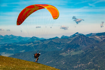 Alpine summer view with a paraglider taking off at Koessen, Kitzbuehel, Tyrol, Austria