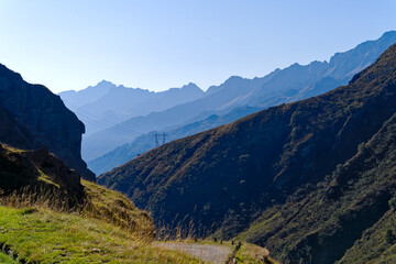Fototapeta premium Scenic view of mountain pass road named Tremola at Swiss mountain pass Gotthard on a sunny late summer day. Photo taken September 10th, 2023, Gotthard, Canton Ticino, Switzerland.