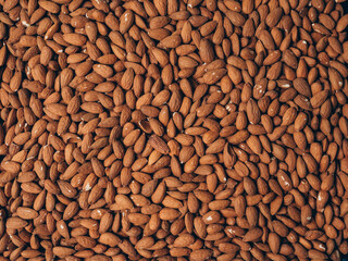 Almond background. Almonds top view background. Whole almond nuts flat lay