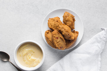Overhead view of akara and nigerian akamu or pap, flatlay of nigerian akara fried bean cake and akamu ogi pap or corn pudding