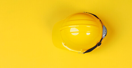 Yellow safety helmet on yellow background.