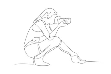 Woman taking photos while squatting. World photography day concept one-line drawing