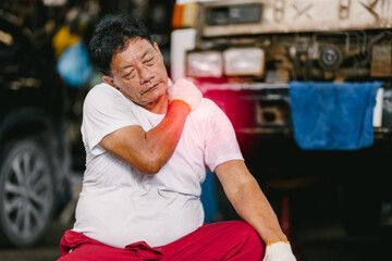 Adult senior Asian worker man muscle join shoulder neck pain syndrome from hard work in heavy...