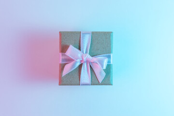 Gift box in vibrant bold gradient holographic colors. Christmas and New Year minimal art concept.