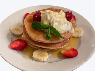 Pancakes topped with honey Serve with strawberries and banana slices.