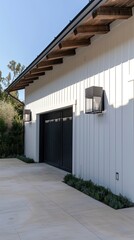 An outdoor light on the side wall of a garage, taken during the evening with natural lighting, illuminating and casting warm light over part of one door.
