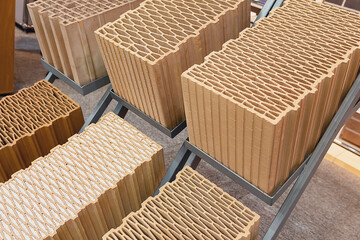 Various types of building hollow red bricks with different patterns inside. samples for sale at diy...