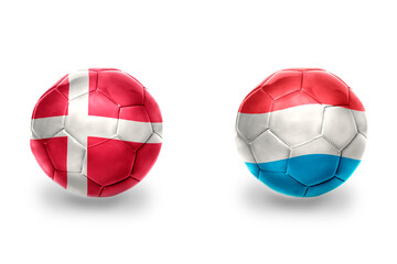 football balls with national flags of luxembourg and denmark ,soccer teams. on the white background.