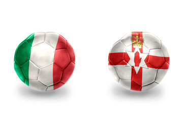 football balls with national flags of northern ireland and italy ,soccer teams. on the white background.