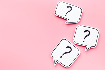 Ask concept. Question mark on paper speech bubble, top view