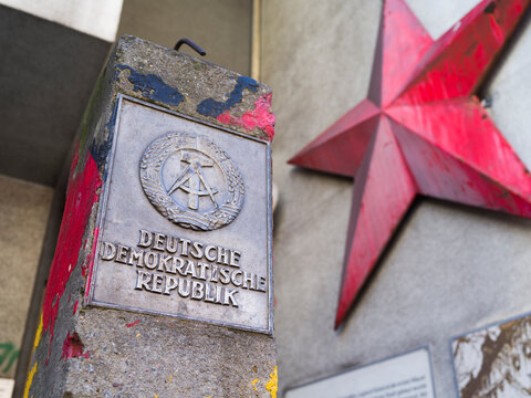 Berlin, Germany, April 27th 2024, Deutsche Demokratische Republic marker at Checkpoint Charlie with Soviet red star.
