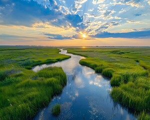 Fototapeta premium Serene Saltwater Marsh at Sunset with Flowing Creek and Reflective Waters