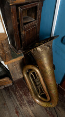 Embrace rustic charm with vintage brass tuba and wooden furniture, a blend of tradition and music
