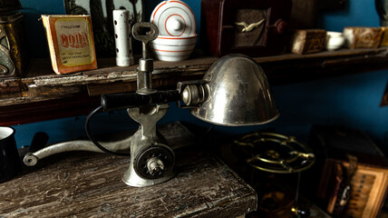 Vintage Metal Lamp displayed on an Antique Shelf along with Various Decorative Items