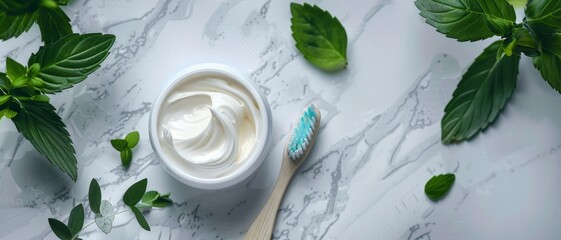 A white jar of cream sits on a marble countertop next to a toothbrush