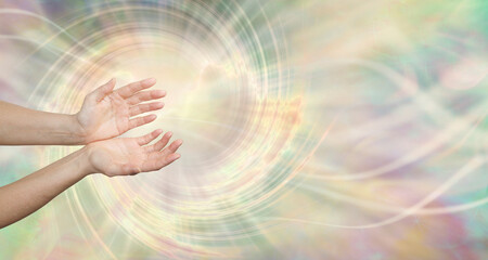 Healer working with spiraling Quantum Energy field - female open cupped hands in a vortex of...