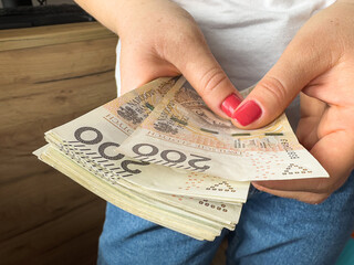 woman count polish money pln zl zloty banknotes for shopping