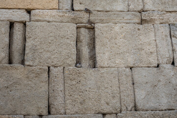 The fortress wall. Sparrows on the ancient fortress wall. The wall is made of large stone blocks. Large stone blocks are prone to erosion.
