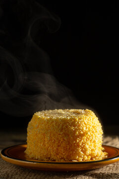 Dish of couscous "cuscuz brasil" "Cuscus,Cuzcuz,Cuscuz" individual portion, mini traditionally from the north and northeast of Brazil, typical food of Brazilian cuisine, on a rustic wooden table