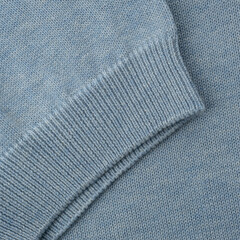 Elastic band close up on the sleeve of a light blue-gray knitted cotton polo t-shirt