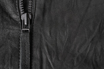 Crumpled black suede textured horizontal background with black metal zip