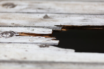 Close-up of Weathered Wooden Surface with Cracked and Broken Planks, Rustic Texture, Old Wood,...