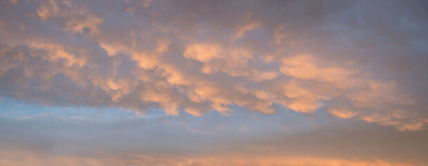 sunset sky background with mammatus clouds yellow and grey
