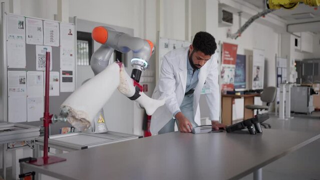 Robotic engineer working on robotic knee replacement surgery project. Concept of robotics, engineering and computer science in healthcare.