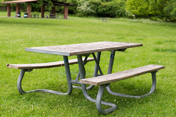 Park Picnic table bench rest relax outdoors. Benches and tables on green grass in recreational area.