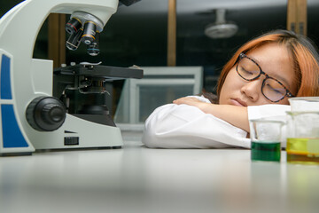 girl scientist sleeping in laboratory. emotion of education and science