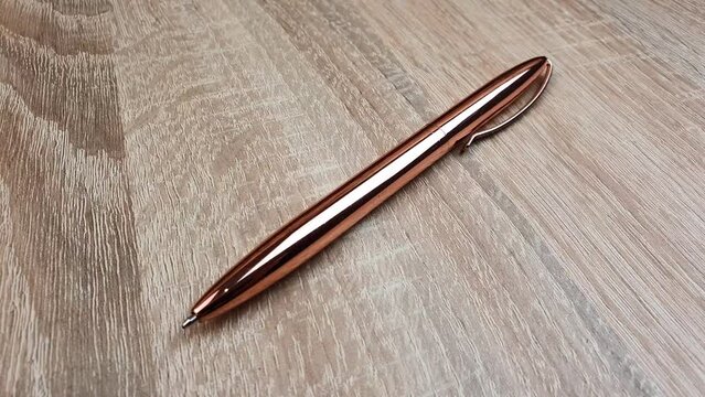 Metal ballpoint pen on the table. Pen, note taking accessory.