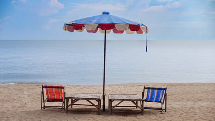Chairs and umbrellas on the beach in beautiful sky.