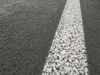 Road markings. White on gray and black. Abstract drawing art