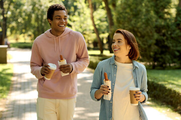 A diverse, loving couple walking down a scenic sidewalk in vibrant attire, enjoying each others...