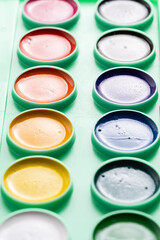 Full palette of watercolor paints in daylight.