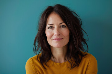 A close up portrait of a woman with a subtle smile