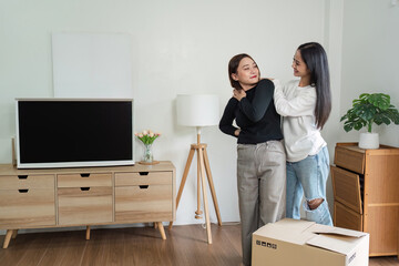 Happy Lesbian Couple Moving into New Home - LGBT loving and New Beginnings - Unpacking Boxes, Decorating, and Creating a Cozy Space Together