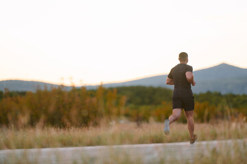 Athletic Man Jogging in the Sun, Preparing His Body for Life's Extreme Challenges