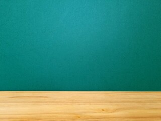 Empty wooden table and green wall
