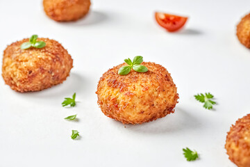 Close-up of Crispy Fried Arancini with Parsley Garnish
