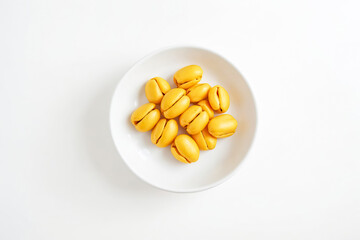 Fototapeta premium Yellow Fruit in White Bowl