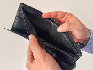 Man shows empty wallet isolated on white. Bankruptcy and financial problems concept