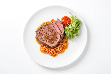 Beef steak with noodles and salad on white plate