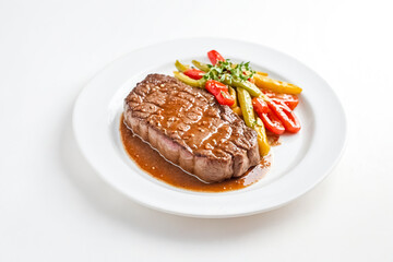 Grilled Steak with Roasted Vegetables on a White Plate